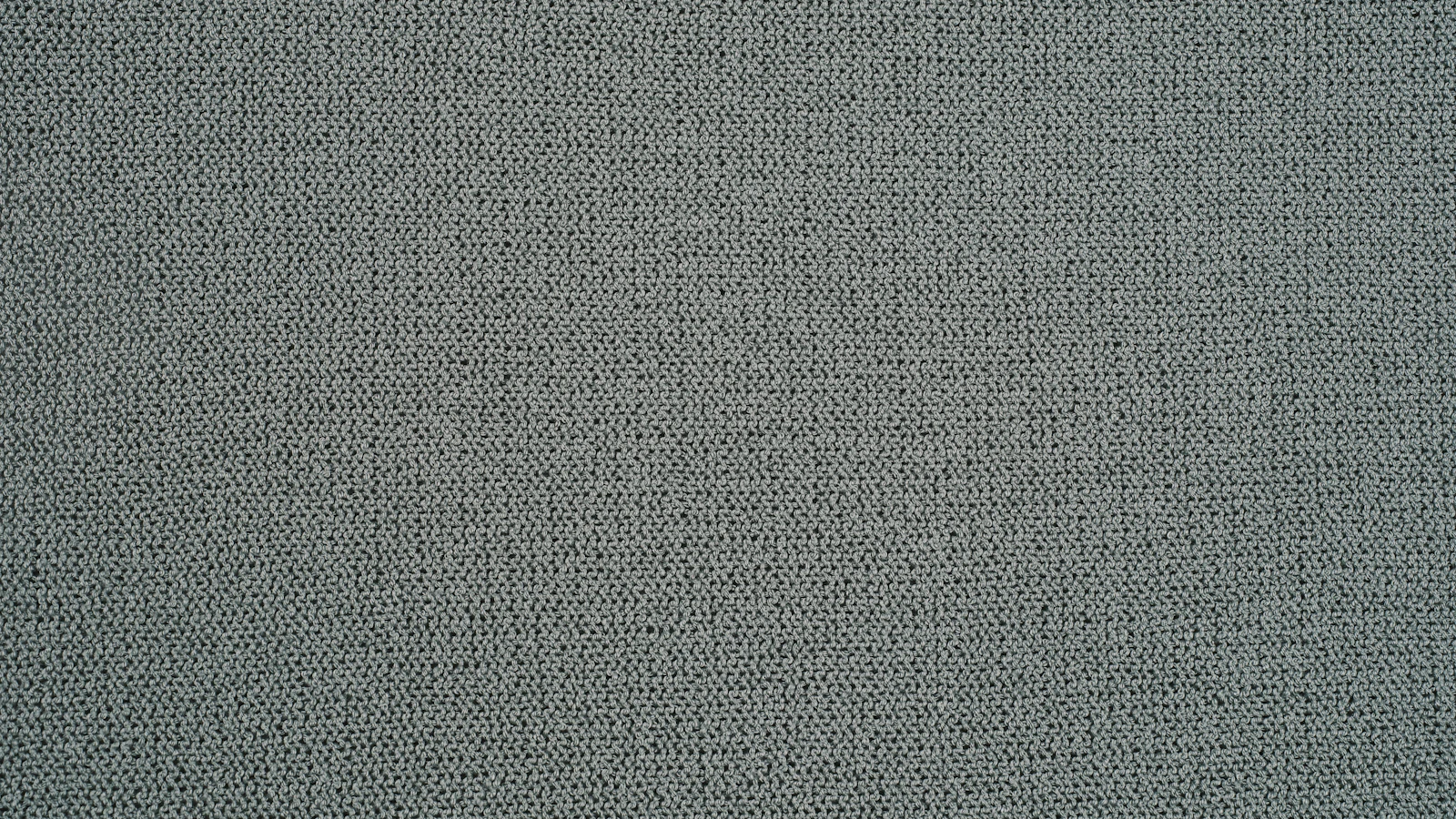 Grau-beiger, grob strukturierter Canvas-Stoff.